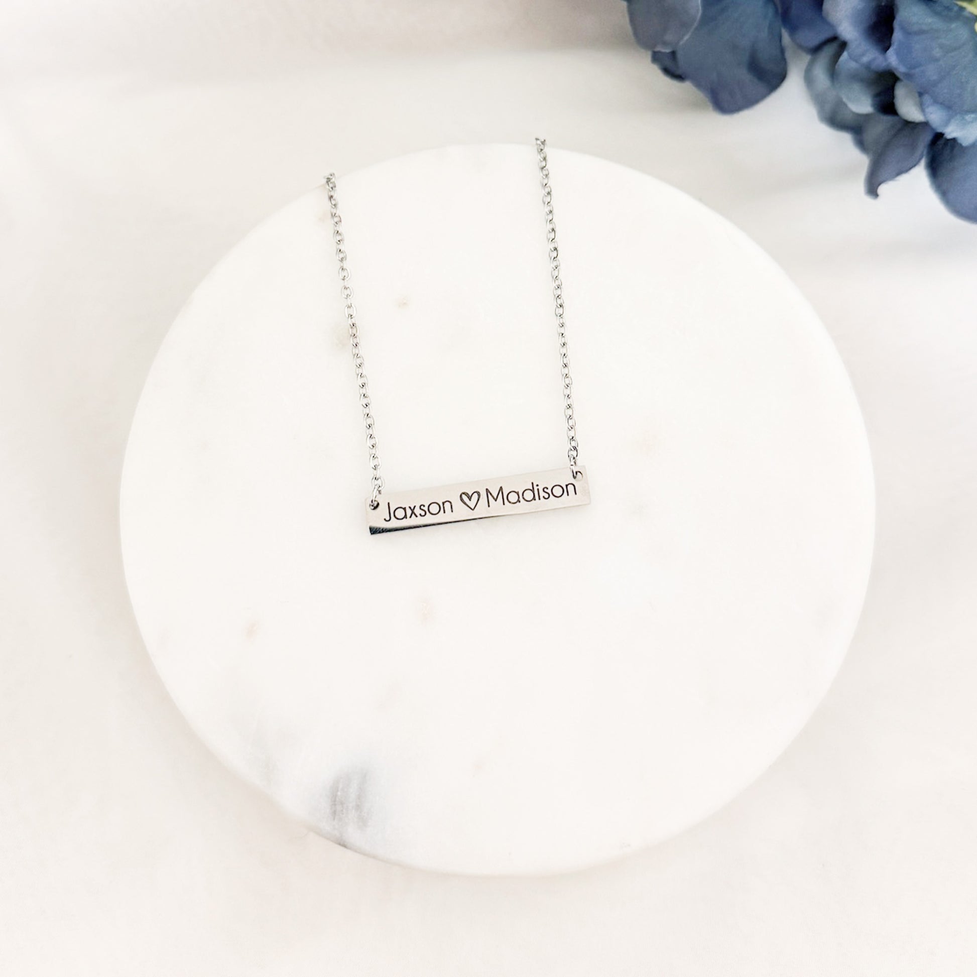 Custom engraved horizontal bar necklace in stainless steel with a sleek 18-inch chain. Personalize it with names, dates, or quotes.