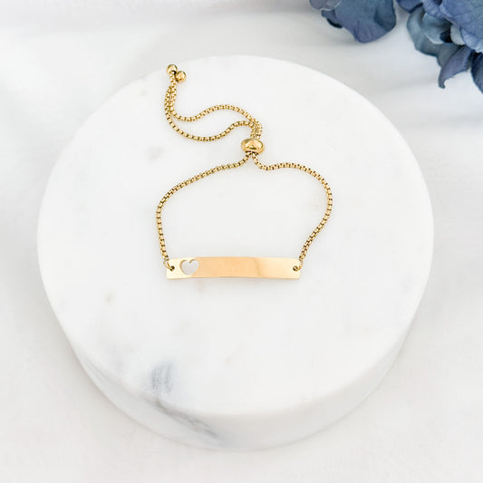 Personalized horizontal bar bracelet with heart cut-out on the left side, custom engraved with names or dates.