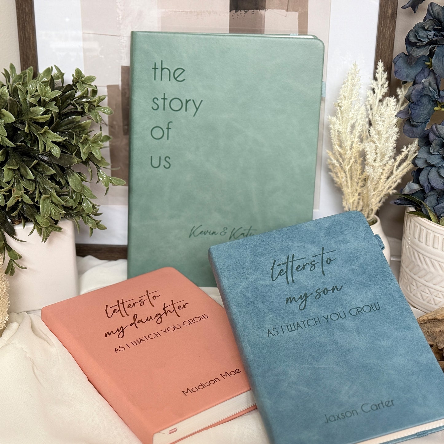 Personalized leather journal in blue, green, and pink with customizable engravings.