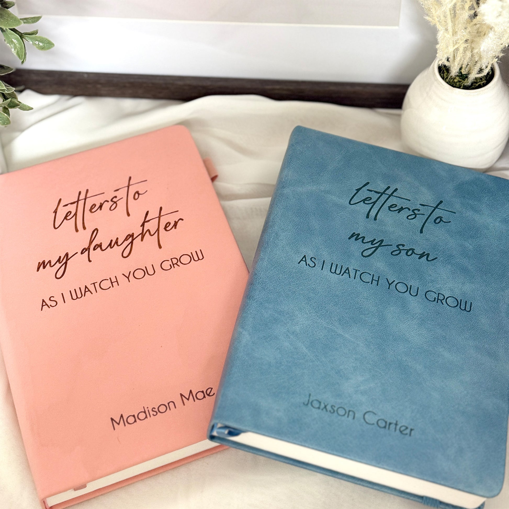 Personalized leather journal in blue and pink with customizable engravings.