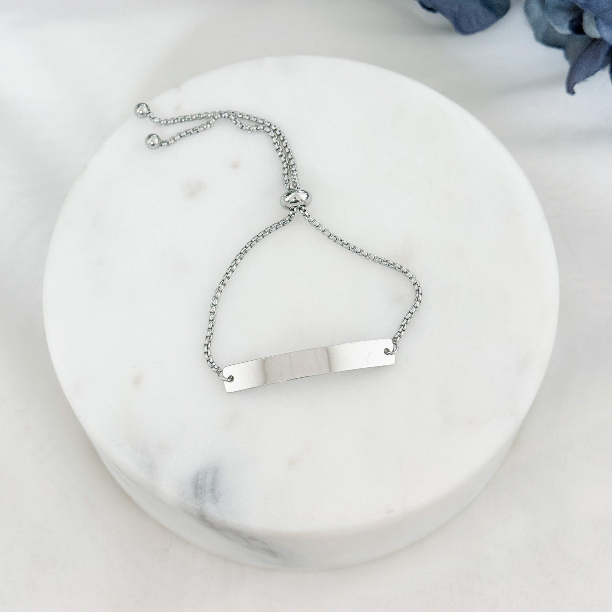 Personalized horizontal bar bracelet with bolo closure, adjustable to any wrist size, available in silver and gold finishes.