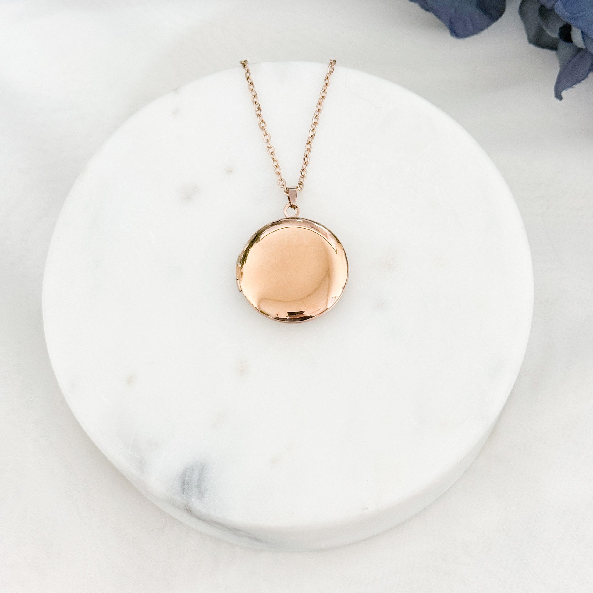 Large round locket necklace with customizable engraving options for names and dates.