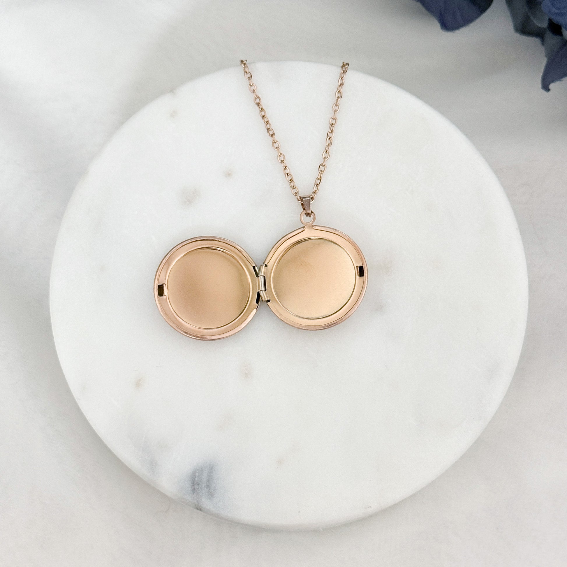 Large round locket necklace with customizable engraving options for names and dates, opened. 