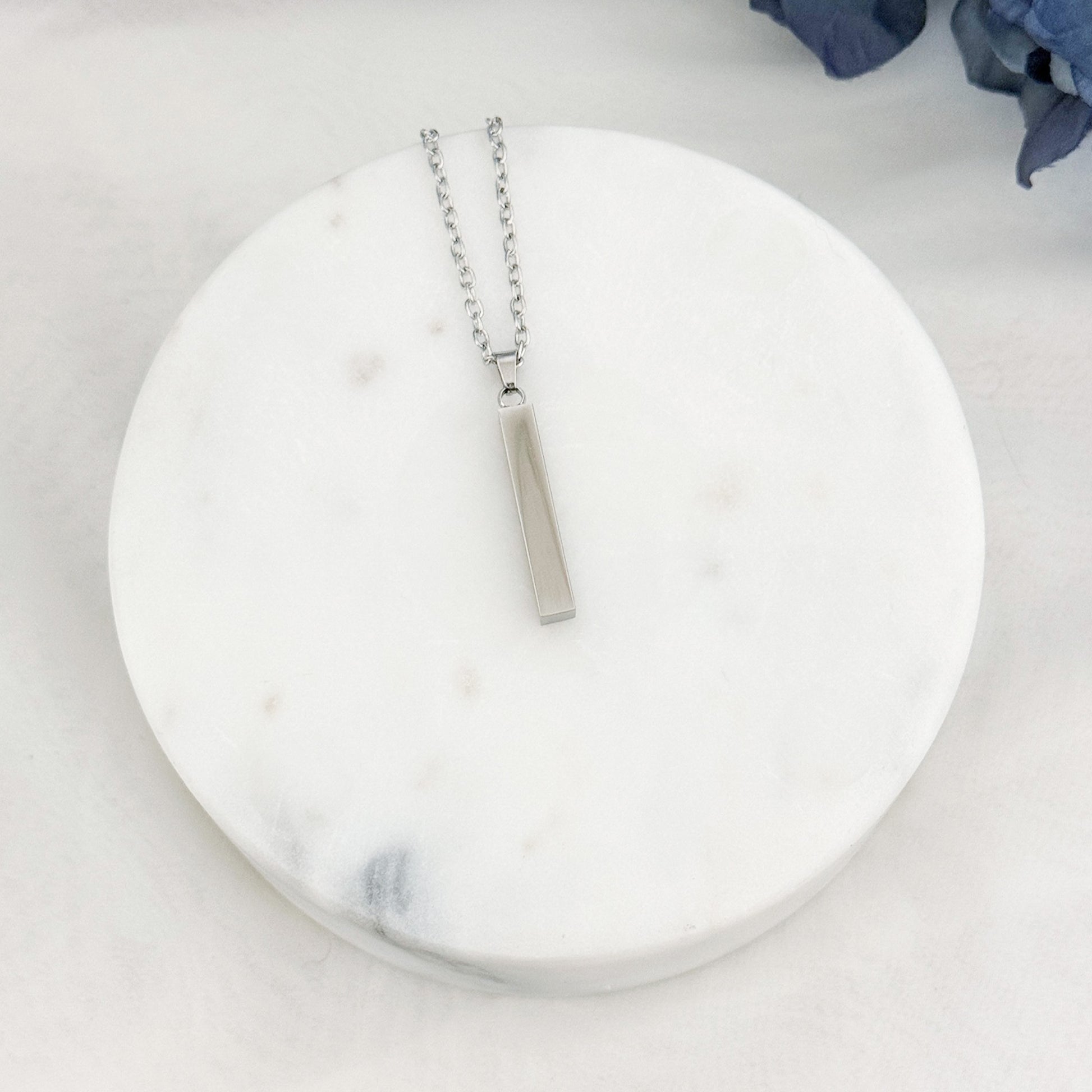 Vertical bar necklace with customizable engraving on all four sides.